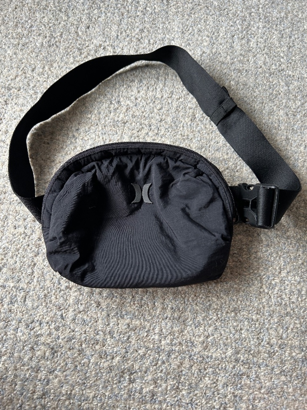 Black Hurley Crossbody Bag features a crinkled taffeta finish